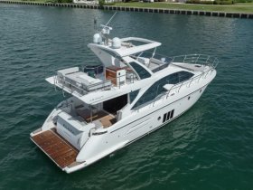 A stunning aerial view of a luxurious yacht, showcasing its sleek design and spacious deck, perfect for upscale boating experiences.