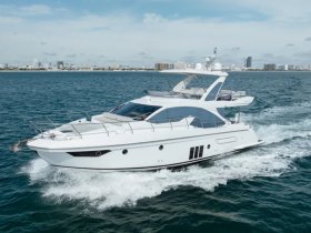 A sleek yacht cruising through clear waters, showcasing its elegant design and modern features — perfect for luxury outings on the water.