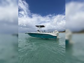 A stunning Angler boat named 'Blue Heaven' anchored in clear turquoise waters, perfect for a day of fishing or leisure on the water.