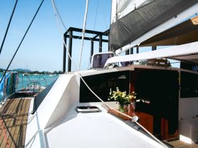 A beautifully arranged interior of a yacht showcasing elegant seating and floral decor, perfect for luxurious cruising experiences.