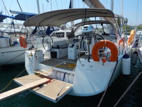 A detailed view of the back of a yacht docked at the marina, showcasing its sleek design and features, perfect for luxury sailing experiences.