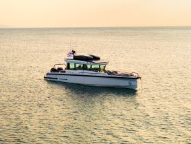 A stunning aerial view of a sleek yacht cruising through calm waters, perfect for luxury charters and scenic adventures.