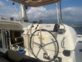 A detailed view of the helm and console area inside a yacht, showcasing the navigation equipment and steering wheel, perfect for sailing enthusiasts.