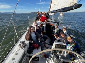 A lively group enjoys a sailing adventure, capturing smiles and camaraderie on the water — perfect for memorable outings with friends.