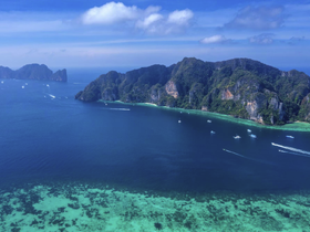 A stunning aerial view of a tropical coastline with lush islands and clear blue waters, showcasing the beauty of nature and ideal for boat tours and exploration.