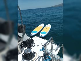 Two paddleboards are neatly arranged on the deck of a boat, ready for adventure on the open water — perfect for exploring coastal areas or enjoying a day of fun in the sun.