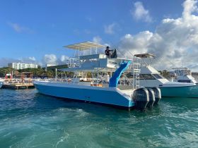 A fishing boat docked at the marina, showcasing its sleek design and equipped for an exciting day on the water.