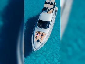 Two friends relax and sunbathe on the deck of a luxurious yacht, surrounded by stunning turquoise waters — an ideal setting for a summer getaway.