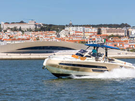 A sleek speedboat named 'Life Changer' glides through the water, showcasing its elegant design against the vibrant backdrop of Lisbon's skyline.