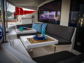 A beautifully arranged dining area inside a yacht, featuring elegant table settings and comfortable seating — perfect for enjoying meals while cruising.