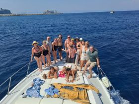 A lively group enjoys a fun day on the water, celebrating together aboard a boat — perfect for summer outings and memorable gatherings.