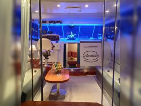 Interior view of the cabin on the Anastasia boat, showcasing a comfortable seating area and helm, perfect for relaxing and navigating on the water.