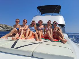 A fun group of friends celebrates aboard a yacht, enjoying the sun and each other's company — perfect for bachelorette parties or summer getaways.
