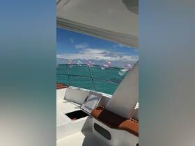 A cozy interior view of a boat featuring seating and colorful balloons, perfect for celebrations on the water.