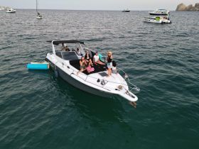 A lively group enjoys a day on the water aboard a boat, capturing fun moments and relaxation under the sun.