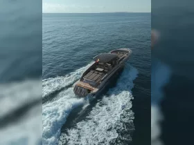 A stunning aerial view of a sleek speedboat cruising through clear waters, showcasing its elegant design and powerful performance.