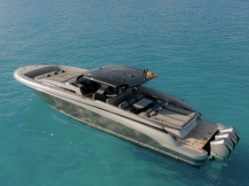 A stunning aerial view of a sleek speedboat cruising through crystal-clear waters, perfect for thrilling adventures on the open sea.