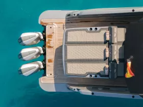 Aerial view of a sleek speedboat showcasing its spacious deck and powerful engines, perfect for thrilling adventures on the water.