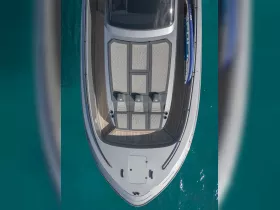 Aerial view of a sleek speedboat showcasing its spacious deck and seating area, perfect for enjoying sunny days on the water.