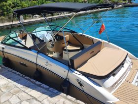 A well-appointed interior view of a sleek boat featuring comfortable seating and a modern helm, perfect for leisurely outings on the water.