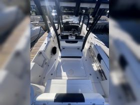 An interior view of a sleek boat helm showcasing modern seating and control features, ideal for comfortable navigation on the water.