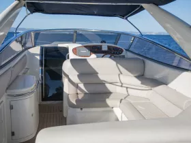 A spacious and well-designed interior of a boat featuring comfortable seating and a helm, perfect for enjoying a day on the water.