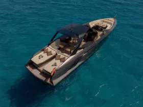 A stunning aerial view of a sleek yacht cruising through crystal-clear waters, showcasing its elegant design and luxurious features.