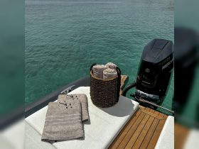 A neatly arranged set of towels on a boat, perfect for a day of relaxation on the water. Ideal for sunbathing or post-swim comfort.