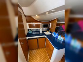 Interior view of a boat's kitchen area, featuring a well-equipped cabin with modern amenities, perfect for preparing meals while at sea.
