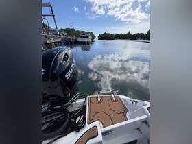 A detailed view of a boat's stern and deck area, showcasing the sleek design and surrounding tranquil waters, perfect for exploring scenic waterways.