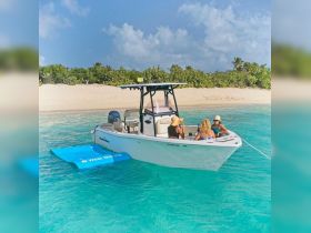 A group of friends enjoys a relaxing day on a boat in crystal-clear waters, perfect for beach outings and fun in the sun.