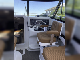 A well-designed helm area featuring comfortable seating and essential controls, perfect for navigating the waters in style.