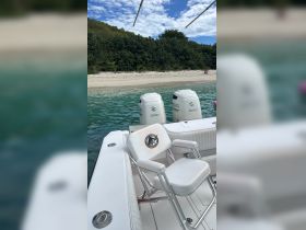 A well-equipped boat interior featuring comfortable seating and powerful Suzuki outboard motors, perfect for fishing or leisure trips on the water.