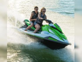 Two riders enjoy an exhilarating ride on a jet ski, showcasing the thrill of water sports and adventure on the open water.
