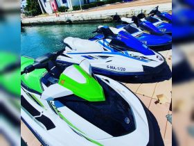 A vibrant lineup of jet skis docked at the marina, perfect for thrilling water adventures and exploring the coastline.