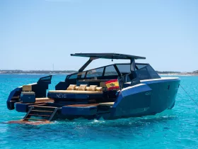A stunning view of the NEVE yacht cruising through crystal-clear waters, showcasing its sleek design and luxurious features.