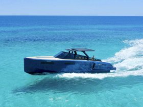 A sleek speedboat glides through crystal-clear turquoise waters, showcasing its modern design and perfect for thrilling adventures on the open sea.