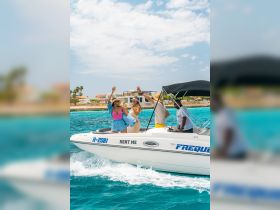 A lively group celebrates on a rental boat, raising their drinks against a backdrop of stunning turquoise waters — perfect for unforgettable adventures on the sea.
