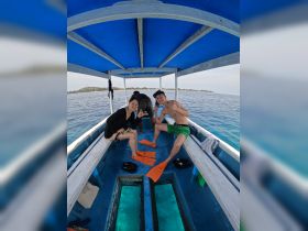 A group of friends prepares for snorkeling on a boat, showcasing excitement and camaraderie on the water — perfect for adventure seekers.