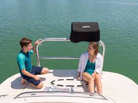 A young boy and girl enjoy a sunny day on the boat, capturing the essence of relaxation and fun on the water.