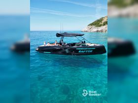 A group enjoys a sunny day aboard the Raptor boat, cruising through crystal-clear waters — perfect for summer adventures and water activities.