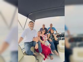A joyful group of friends enjoys a memorable moment aboard a boat, perfect for celebrations and gatherings on the water.