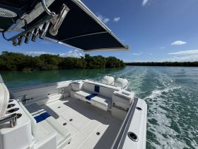 A well-appointed interior view of a boat's helm and seating area, showcasing the sleek design and comfort for a day on the water.