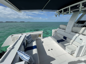 A spacious and inviting interior of a boat featuring comfortable seating and a stunning view of the turquoise waters, perfect for relaxing on a day out at sea.