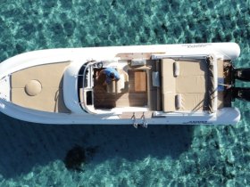 An aerial view of a stylish boat interior featuring comfortable seating and a helm, showcasing the perfect setup for a day on the water.