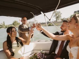 A joyful group toasts with champagne aboard a boat, celebrating a special occasion — perfect for weddings or memorable gatherings on the water.