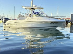 A Wellcraft boat docked in calm waters, showcasing its sleek design and reflective surface — perfect for fishing or leisure outings.