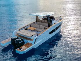 A stunning aerial view of a sleek yacht gliding over calm waters, showcasing its elegant design and spacious seating area, perfect for luxurious outings.
