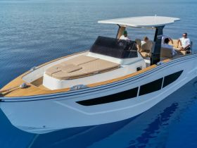 A group of friends relaxes on a stylish boat, enjoying the serene ocean views — perfect for a day of leisure on the water.
