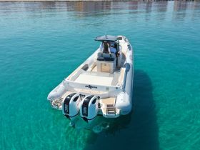 Aerial view of a sleek speedboat cruising through crystal-clear waters, showcasing its modern design and inviting atmosphere for a day on the sea.